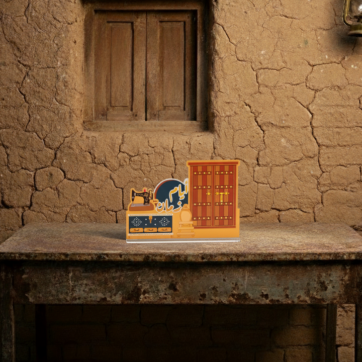 Decorative items on a table in front of a rustic wall with a window and lantern.